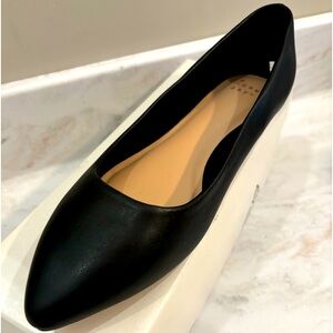 Brand new woman’s black ballet flat shoe.
